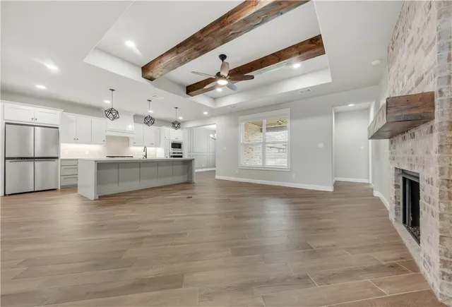 a view of a kitchen with a stove cabinets and wooden floor
