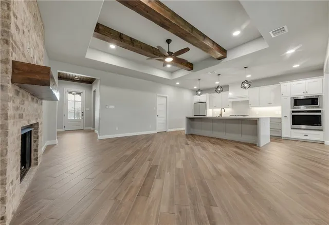 a view of kitchen and hall with wooden floor
