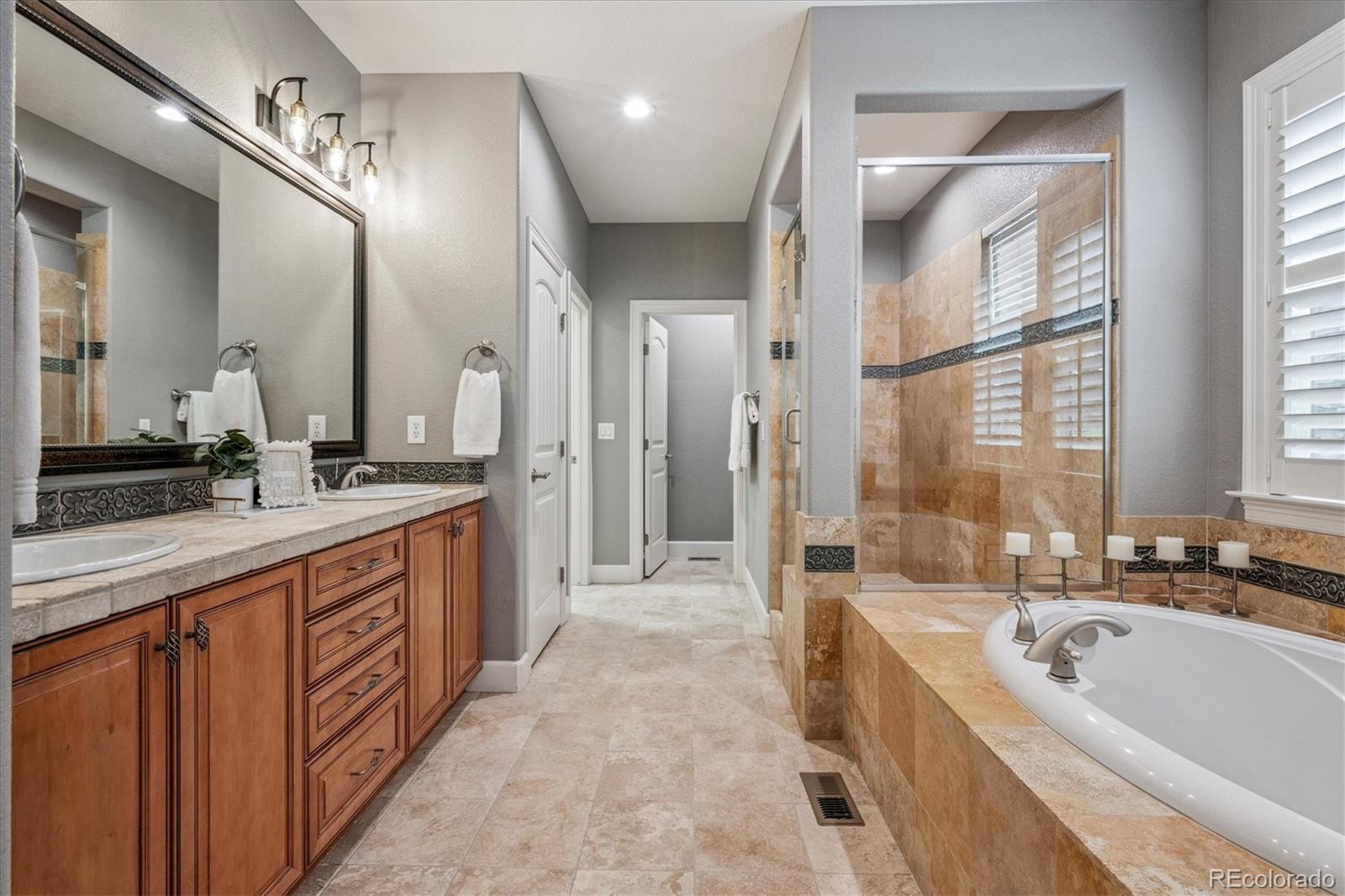 470 Maplehurst Drive Highlands Ranch, CO 80126 - Photo 17 of 46 a large spacious bathroom with a large tub shower and sink