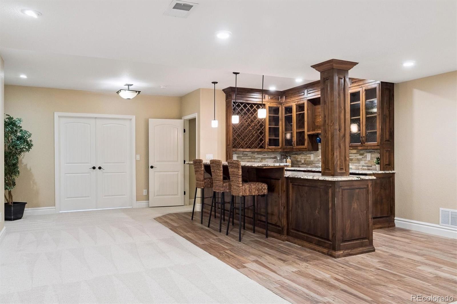 470 Maplehurst Drive Highlands Ranch, CO 80126 - Photo 31 of 46 a open kitchen with stainless steel appliances kitchen island granite countertop a refrigerator and cabinets