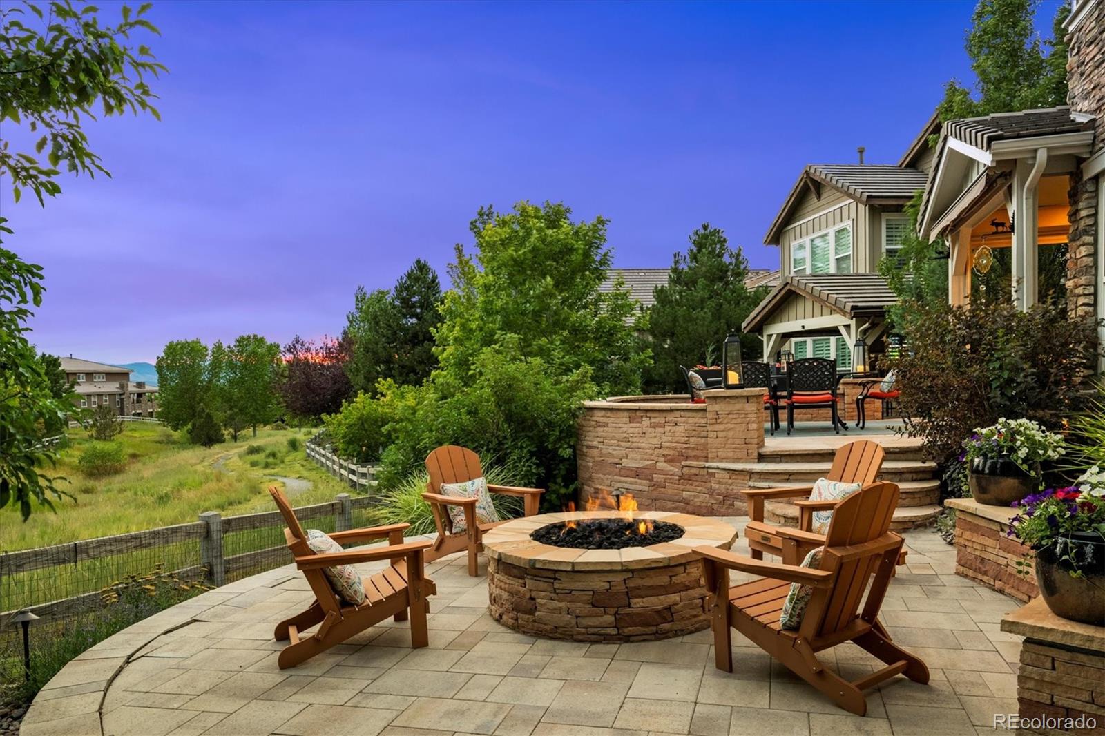 470 Maplehurst Drive Highlands Ranch, CO 80126 - Photo 37 of 46 a backyard of a house with table and chairs