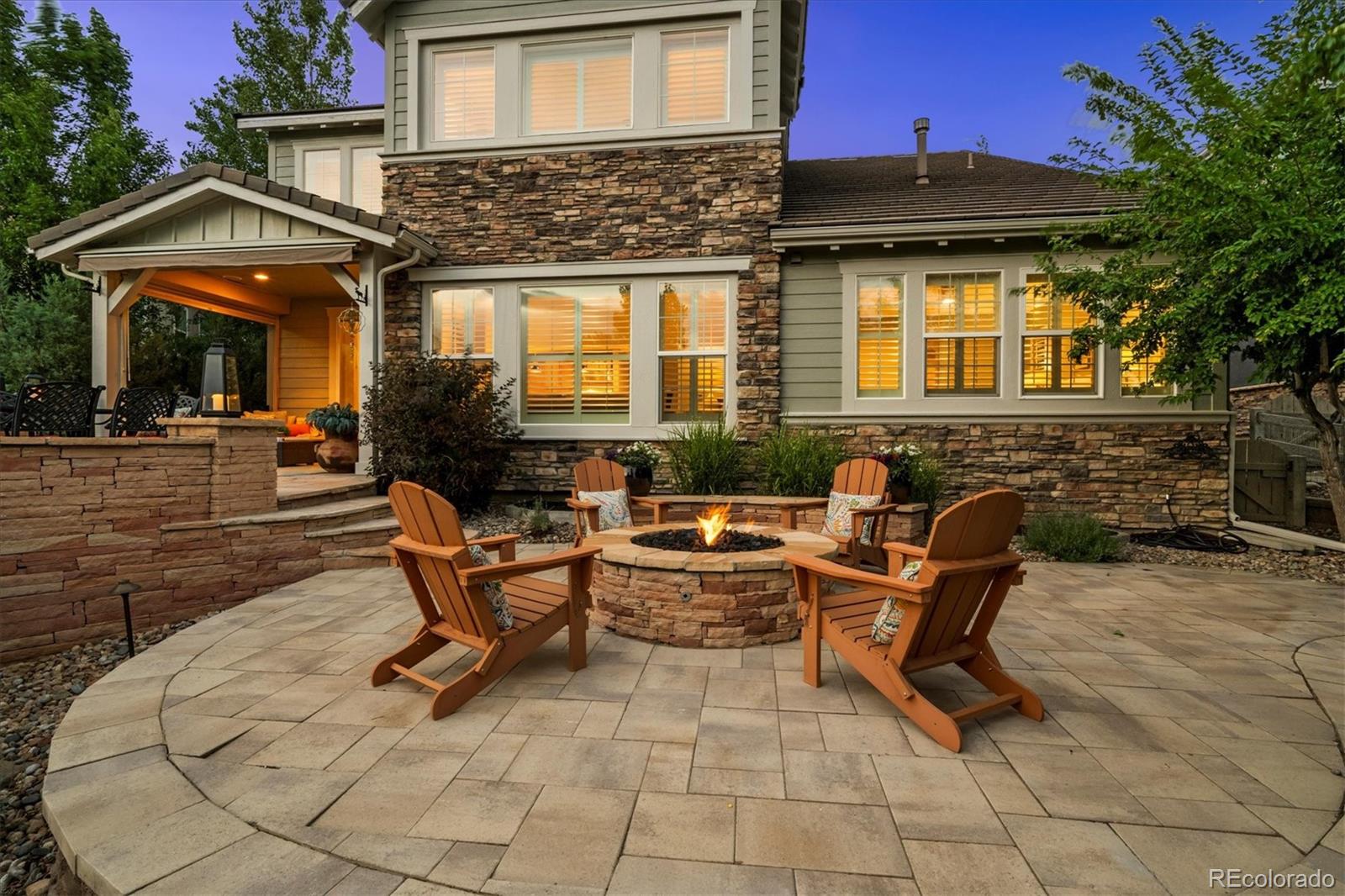 470 Maplehurst Drive Highlands Ranch, CO 80126 - Photo 39 of 46 a view of a patio with table and chairs with wooden floor and fence