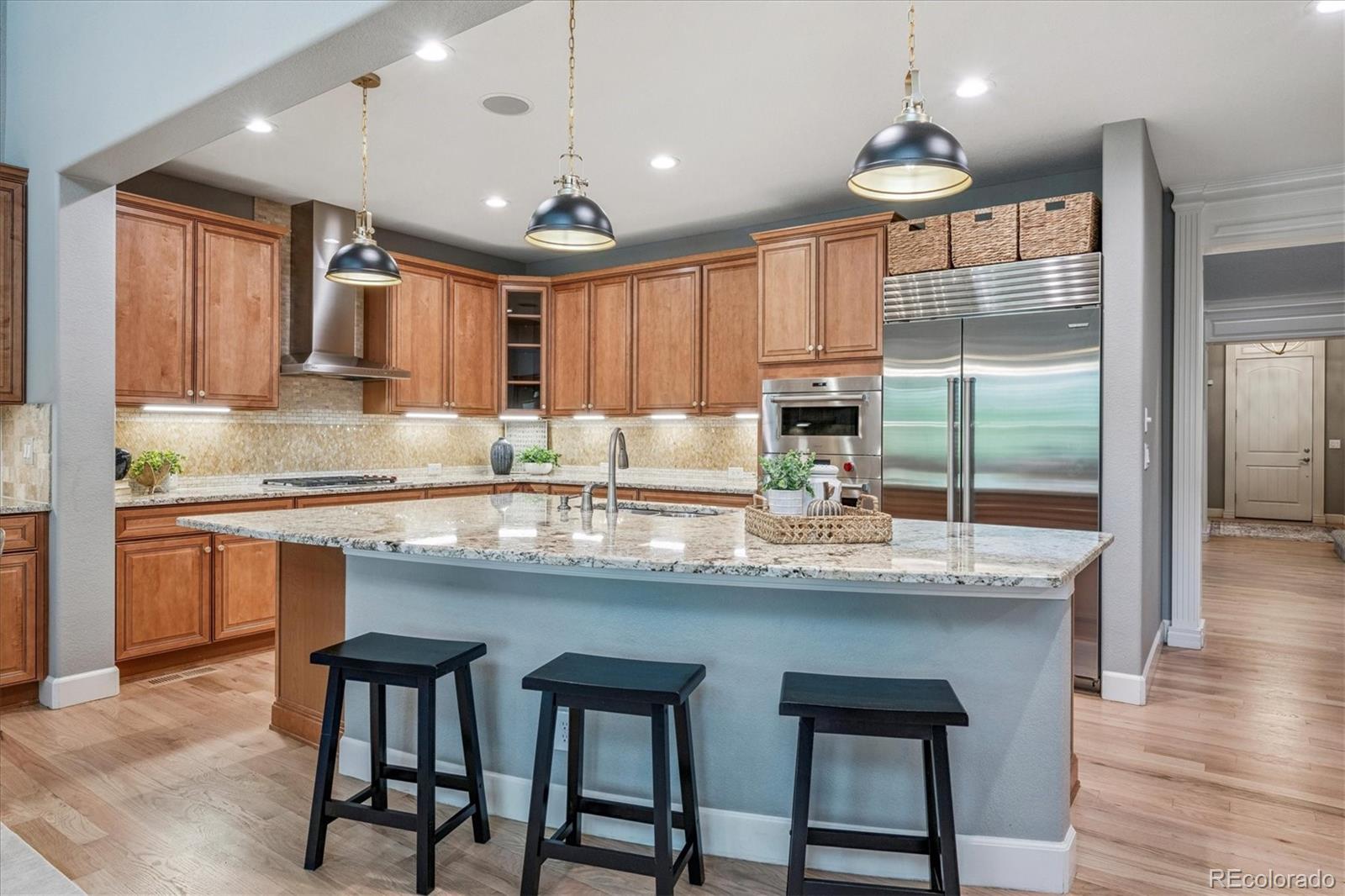 470 Maplehurst Drive Highlands Ranch, CO 80126 - Photo 10 of 46 a kitchen with granite countertop counter space a sink appliances and cabinets