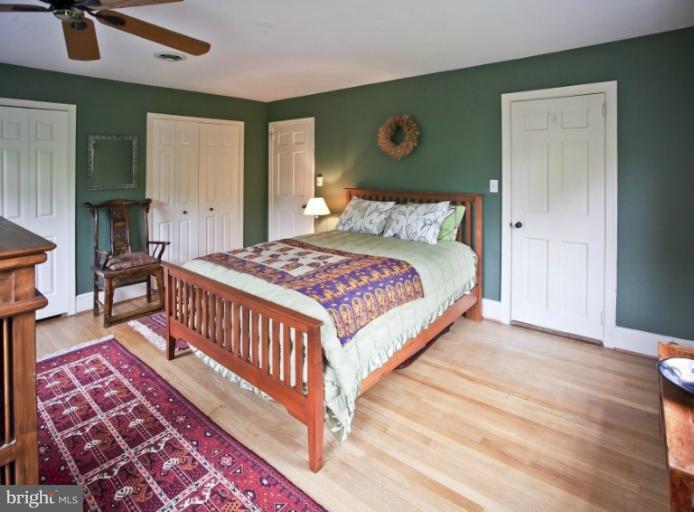 9110 Fairview Road Silver Spring, MD 20910 - Photo 22 of 29 a bedroom with a bed a mirror and dresser