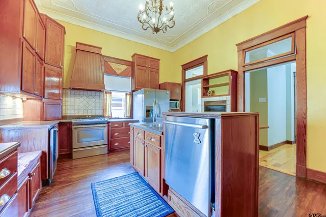 a kitchen with stainless steel appliances granite countertop a stove and a refrigerator