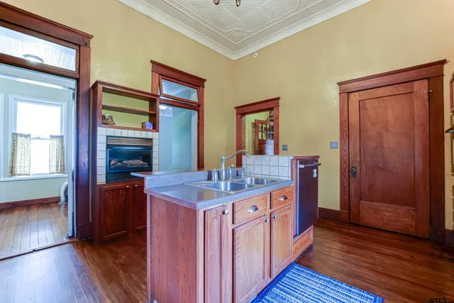 a kitchen with stainless steel appliances granite countertop a sink and wooden cabinets