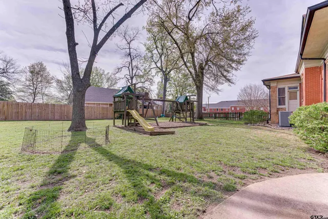 a view of a yard with a house in the background