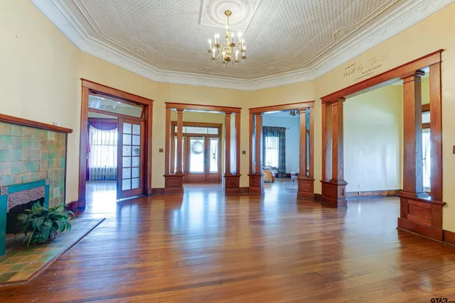 a view of interior space with wooden floor and windows