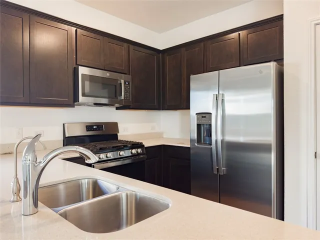 a view of kitchen with microwave and cabinets