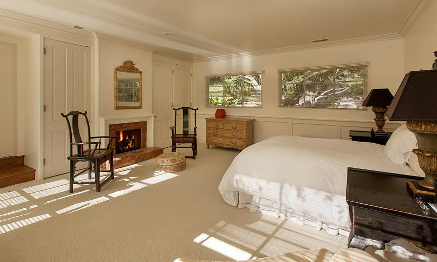 930 Lilac Drive Montecito, CA 93108 - Photo 14 of 25 a spacious bedroom with a bed a table and chair