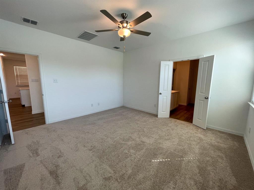 3305 Tulip Poplar Trail McKinney, TX 75071 - Photo 21 of 29 an empty room with closet and a ceiling fan