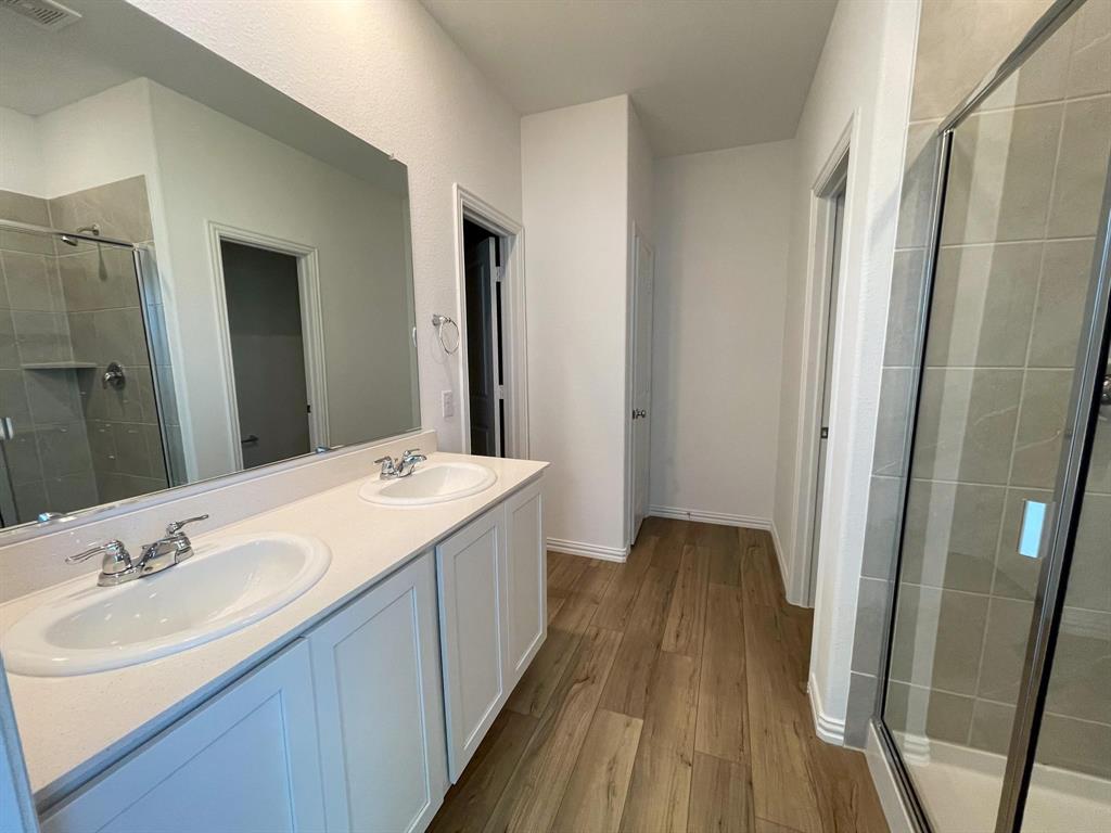 3305 Tulip Poplar Trail McKinney, TX 75071 - Photo 23 of 29 a bathroom with a sink a mirror and a shower