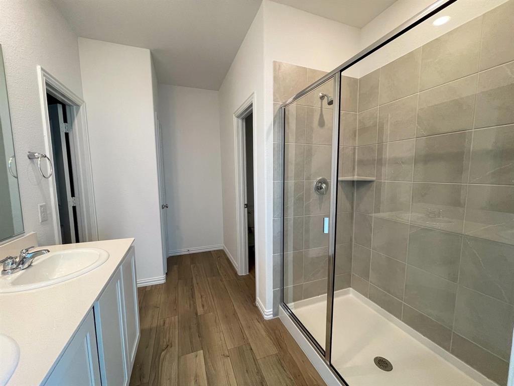 3305 Tulip Poplar Trail McKinney, TX 75071 - Photo 24 of 29 a bathroom with a shower and a sink