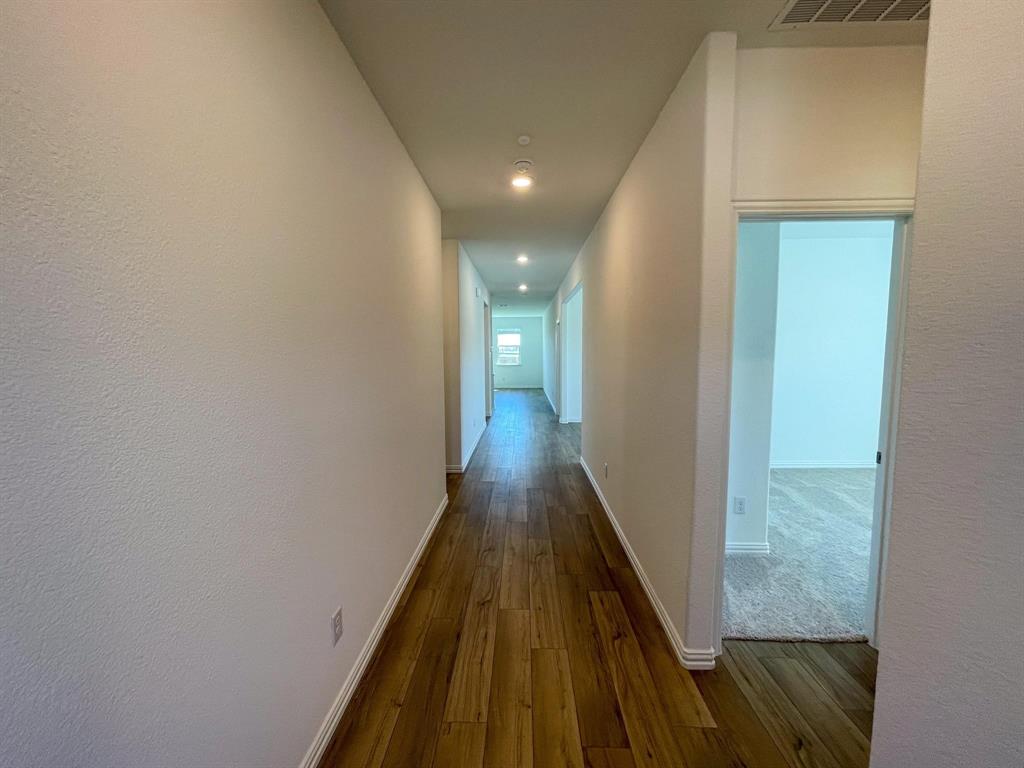 3305 Tulip Poplar Trail McKinney, TX 75071 - Photo 5 of 29 a view of a hallway with wooden floor
