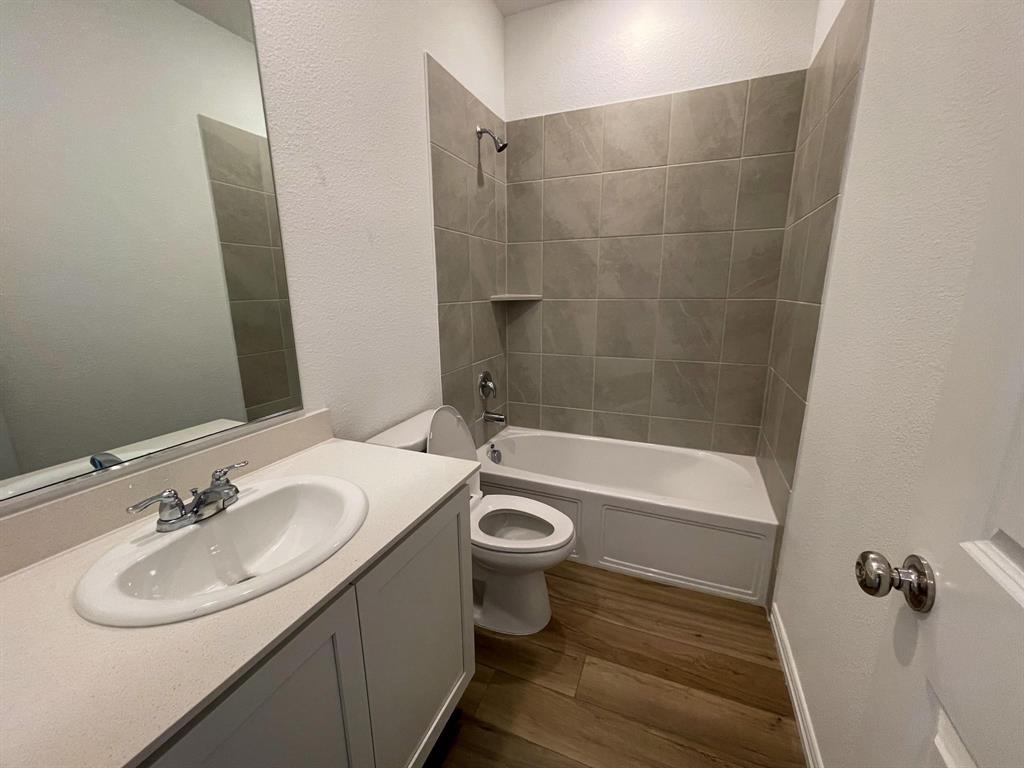 3305 Tulip Poplar Trail McKinney, TX 75071 - Photo 8 of 29 a bathroom with a sink a toilet and shower