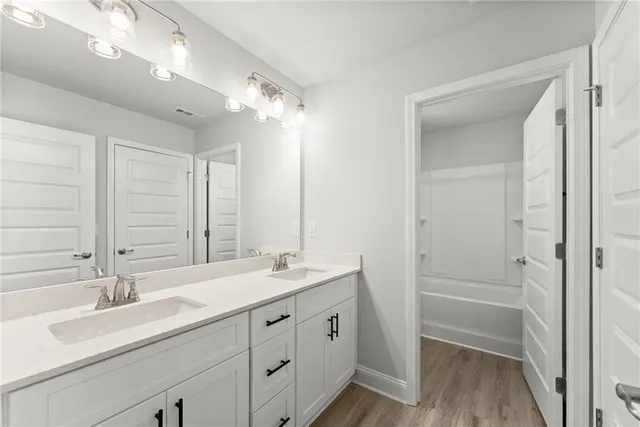 a bathroom with a double vanity sink mirror and double