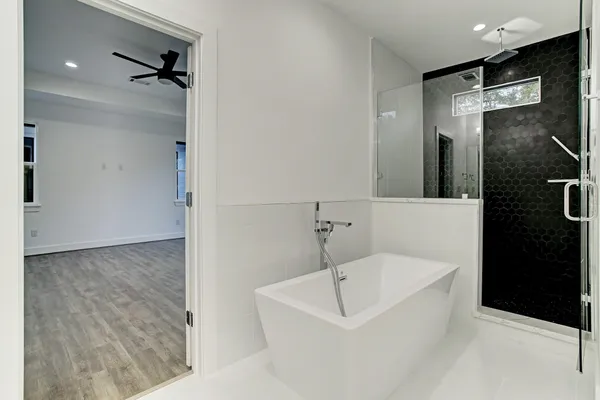 a bathroom with a bathtub and a shower