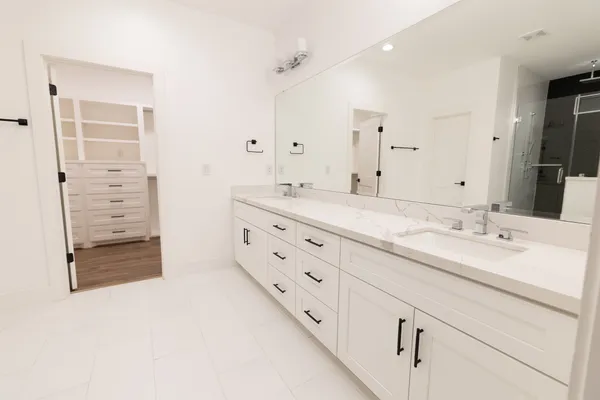 a bathroom with a granite countertop sink mirror and