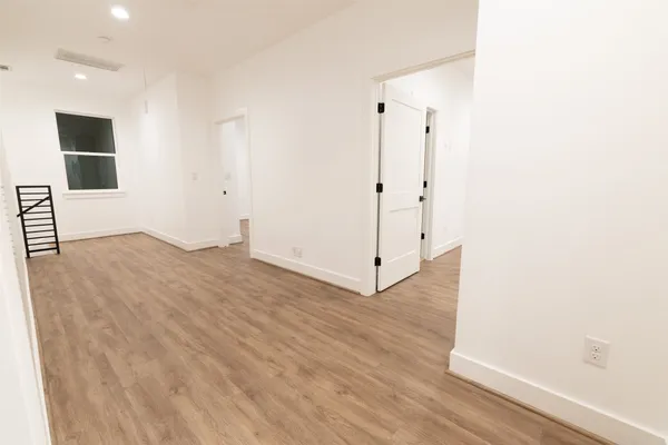 a view of a room with wooden floor