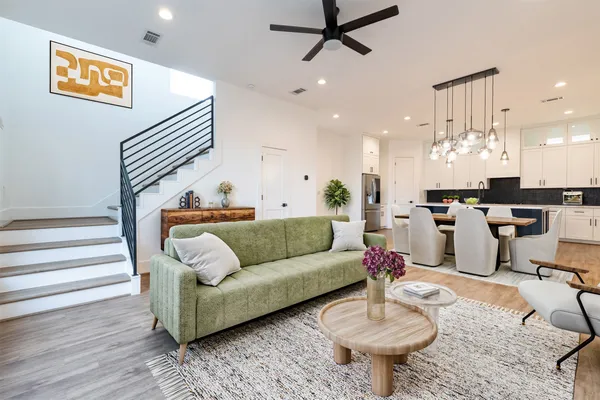 a living room with furniture and kitchen view