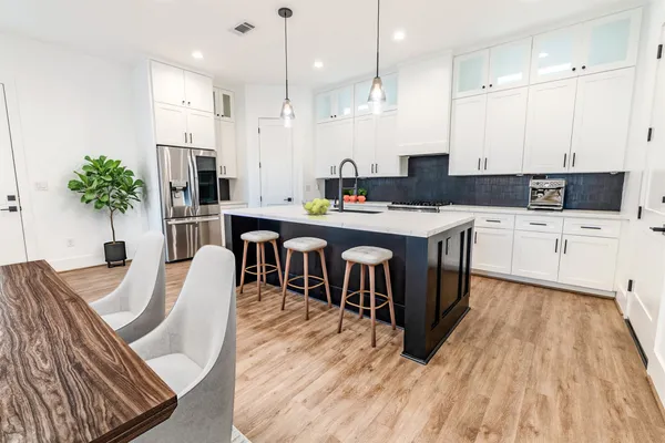 a large kitchen with stainless steel appliances kitchen island a large island in the center