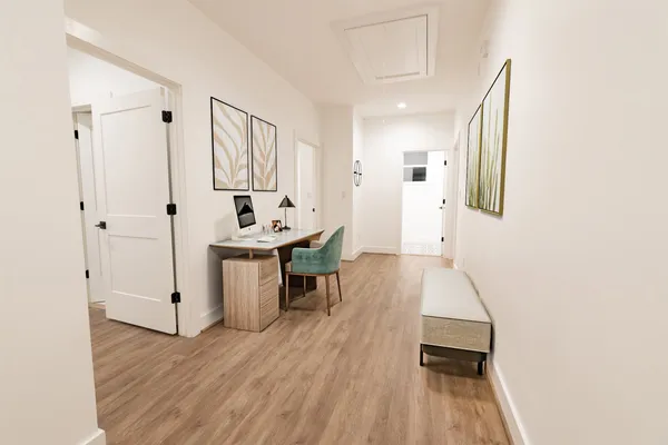 a view of a kitchen with furniture and wooden floor