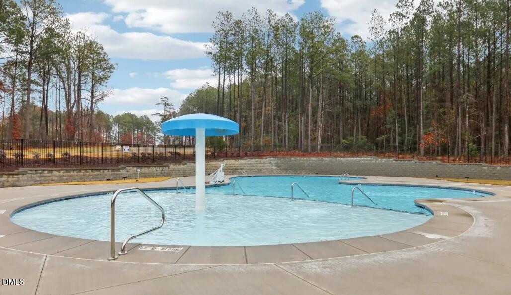 308 Karlov Road Garner, NC 27529 - Photo 53 of 55 a swimming pool with an outdoor seating