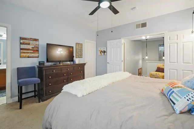 a bedroom with a bed and a painting on the wall