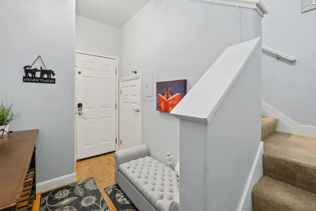 a bathroom with a toilet and a painting on the wall