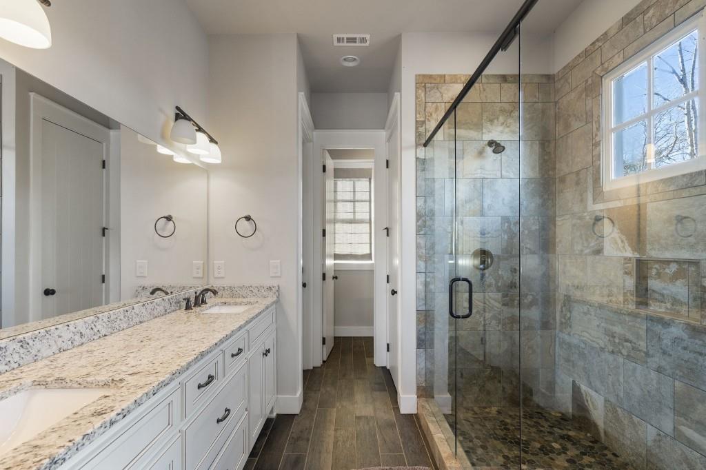 72 Buckeye Ridge Newnan, GA 30263 - Photo 29 of 80 a spacious bathroom with a shower sink and mirror