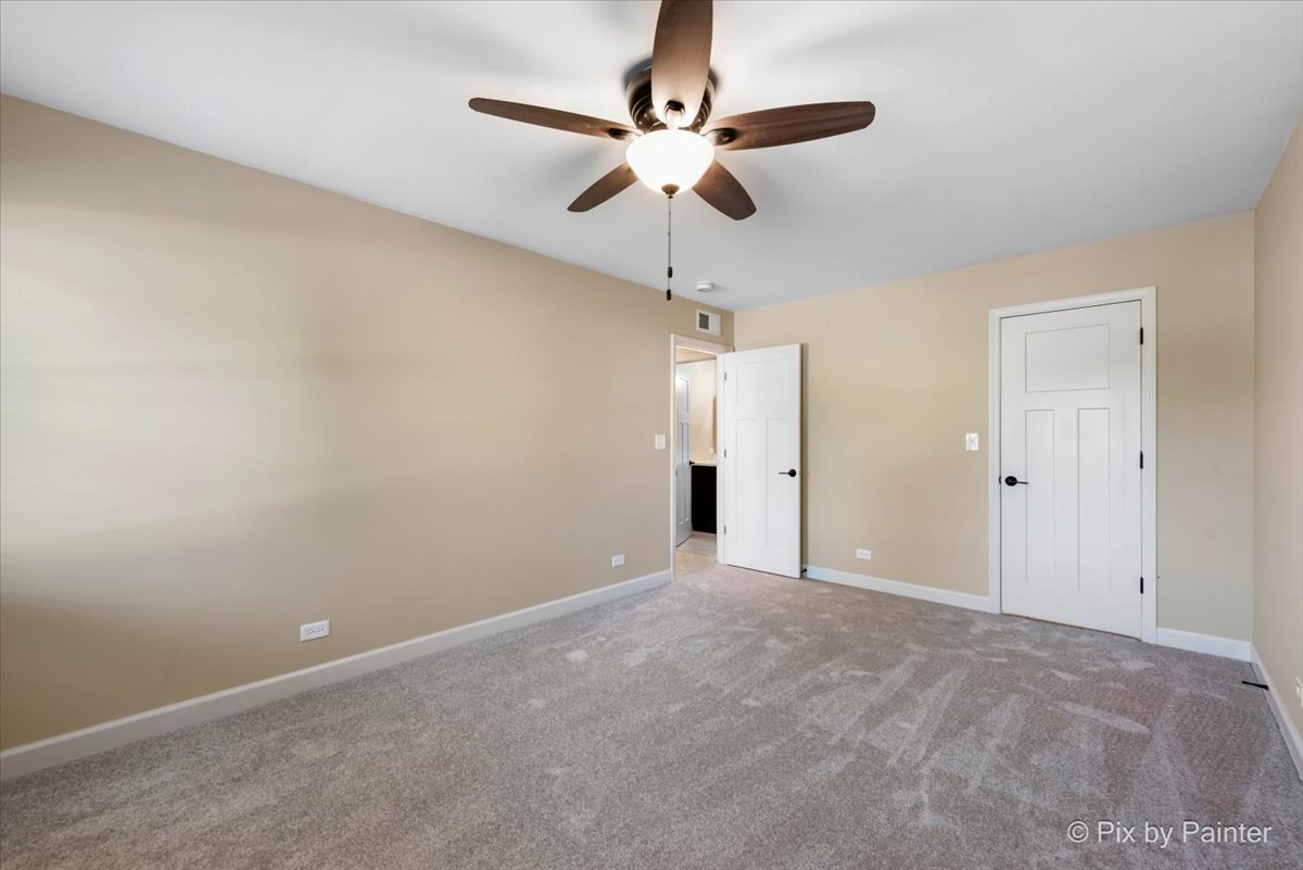 11727 Davey Drive, Unit B Huntley, IL 60142 - Photo 12 of 25 a view of an empty room with a chandelier fan