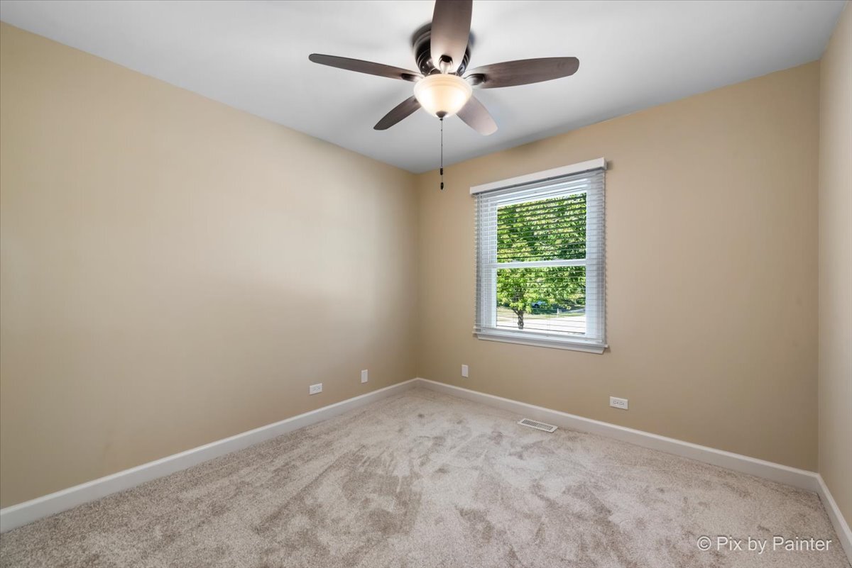 11727 Davey Drive, Unit B Huntley, IL 60142 - Photo 15 of 25 an empty room with a window and a fan