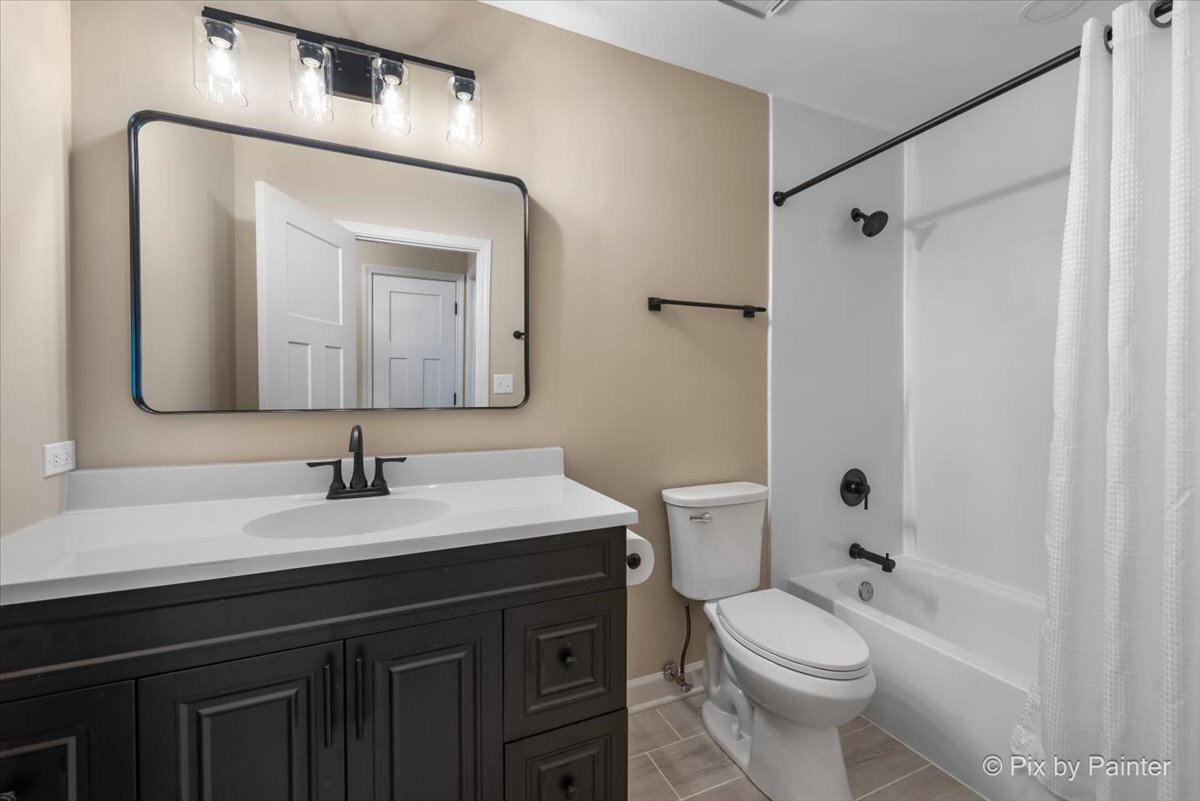 11727 Davey Drive, Unit B Huntley, IL 60142 - Photo 17 of 25 a bathroom with a toilet sink vanity granite and shower