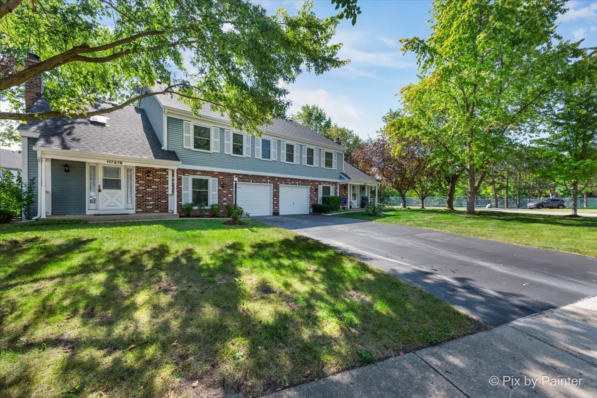 11727 Davey Drive, Unit B Huntley, IL 60142 - Photo 20 of 25 a front view of a house with a garden