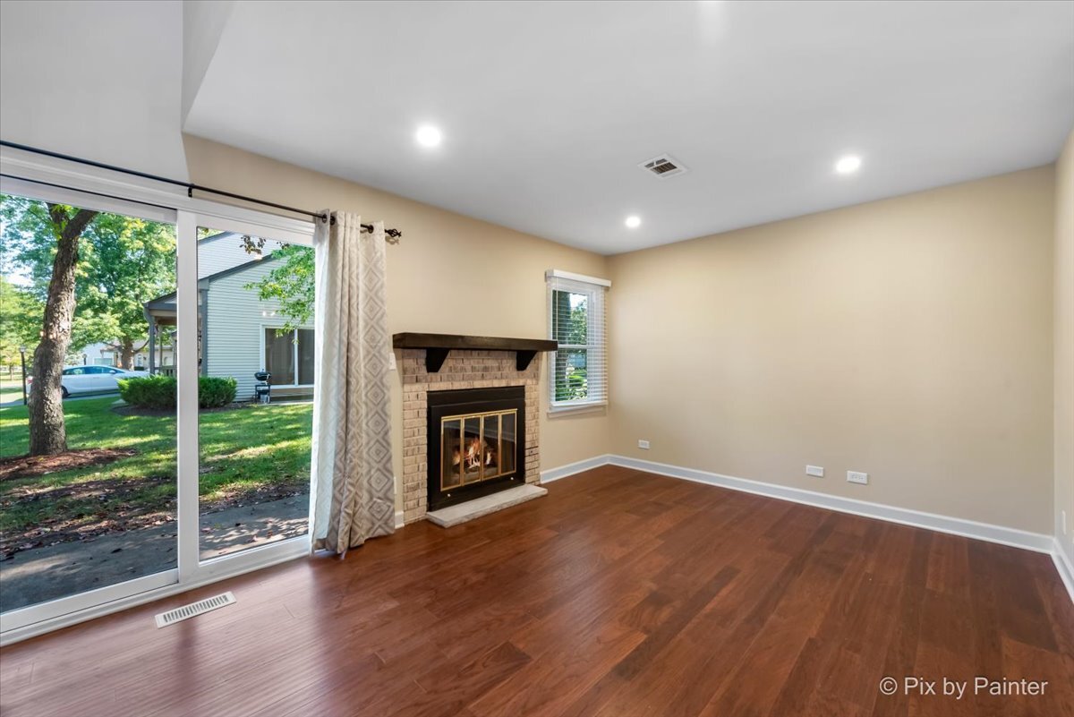 11727 Davey Drive, Unit B Huntley, IL 60142 - Photo 3 of 25 a view of empty room with wooden floor and fireplace