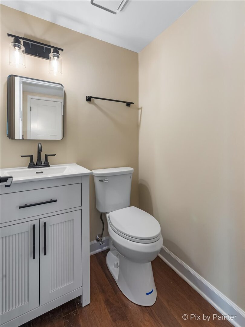 11727 Davey Drive, Unit B Huntley, IL 60142 - Photo 5 of 25 a bathroom with a toilet sink a mirror and vanity