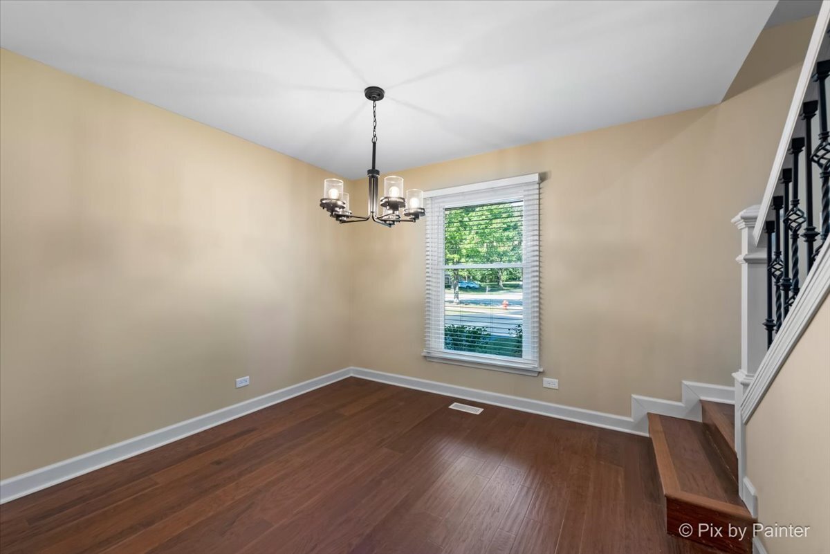 11727 Davey Drive, Unit B Huntley, IL 60142 - Photo 6 of 25 a view of empty room with wooden floor fan and window