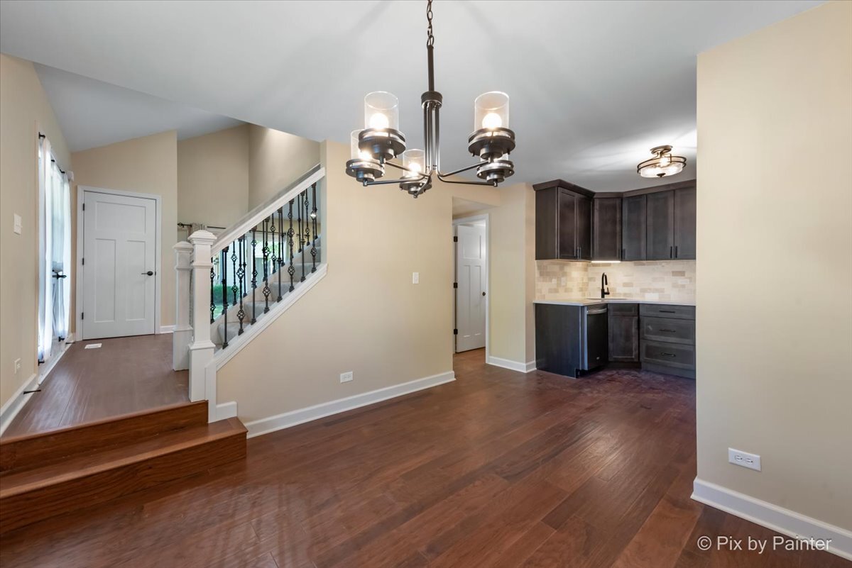 11727 Davey Drive, Unit B Huntley, IL 60142 - Photo 7 of 25 a view of a room with wooden floor and staircase