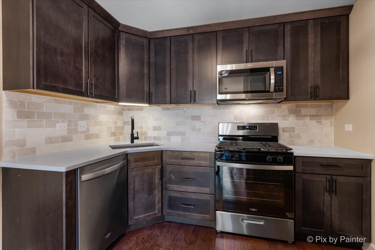 11727 Davey Drive, Unit B Huntley, IL 60142 - Photo 9 of 25 a kitchen with a stove and a microwave