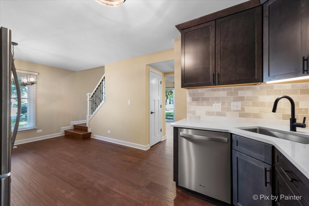 11727 Davey Drive, Unit B Huntley, IL 60142 - Photo 10 of 25 a kitchen with a sink and a stove top oven