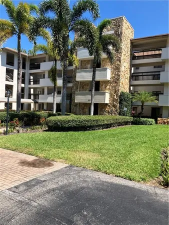 a front view of a residential apartment building with a yard