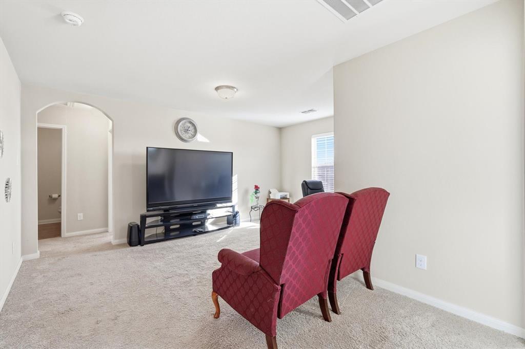 227 Curt Street Anna, TX 75409 - Photo 26 of 40 Living area featuring arched walkways and carpet flooring