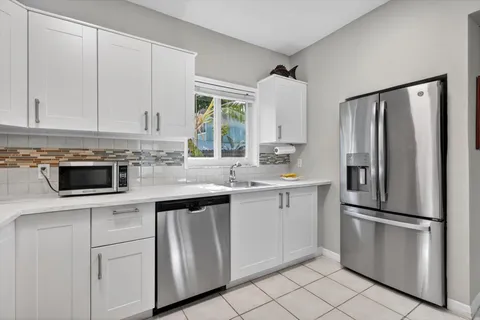 a kitchen with appliances a sink and a counter top space