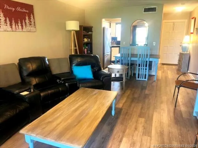 a living room with furniture rug and wooden floor