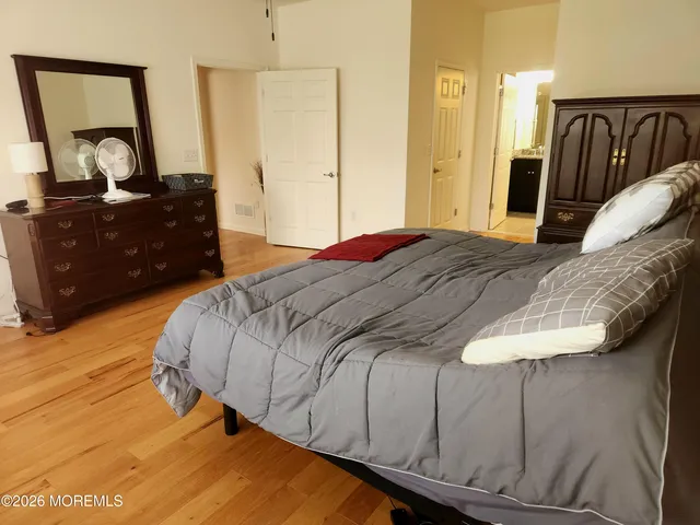 a bedroom with a bed and a dresser