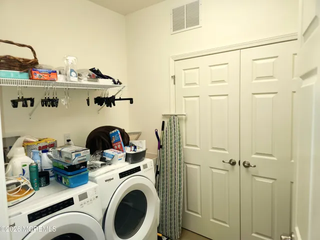 a view of a storage & utility room with washer and dryer