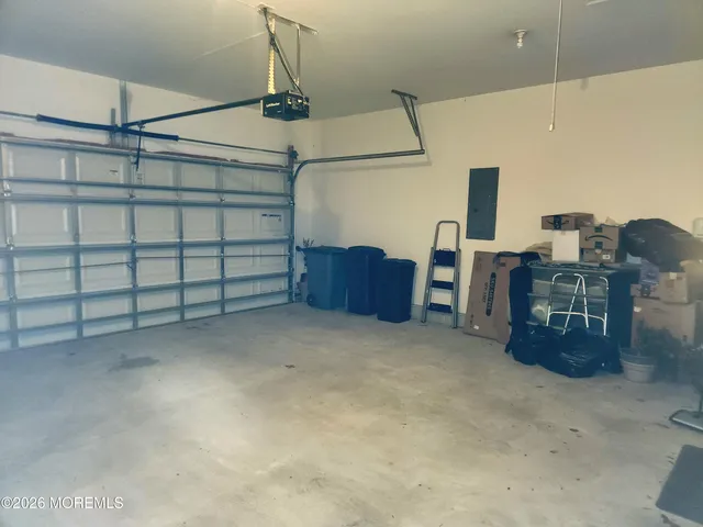 a living room with lots of furniture and view of kitchen