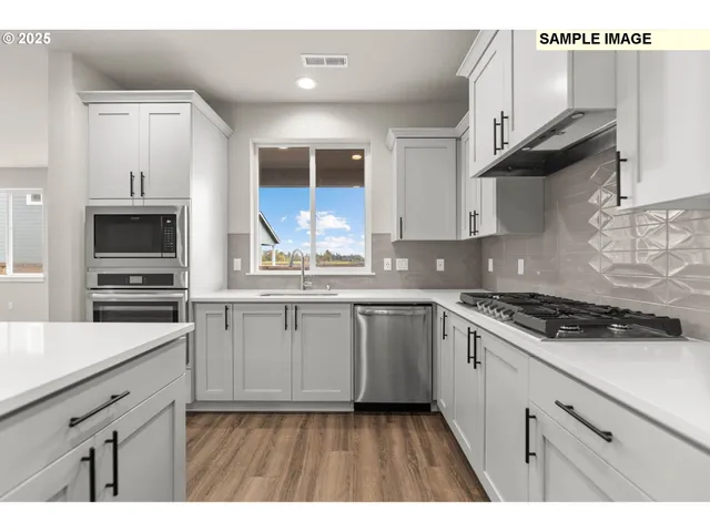 a kitchen with a sink cabinets and window