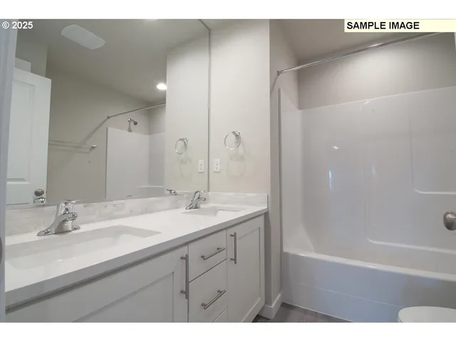 a bathroom with a double vanity sink and a mirror