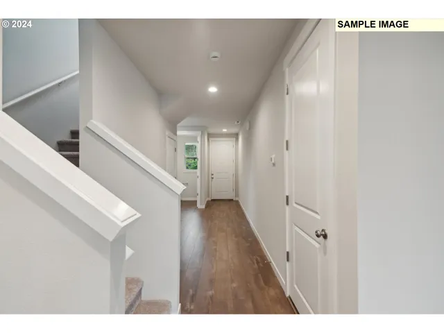 a bathroom with a toilet a sink a mirror and a window